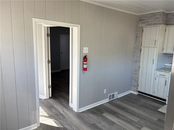 an empty room with wooden floor and closet