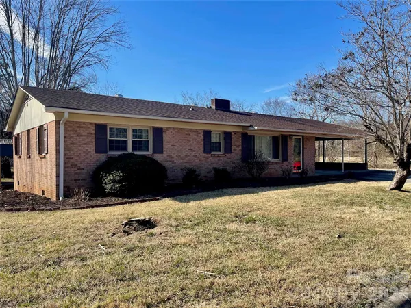 a view of a house with snow on the side of the road
