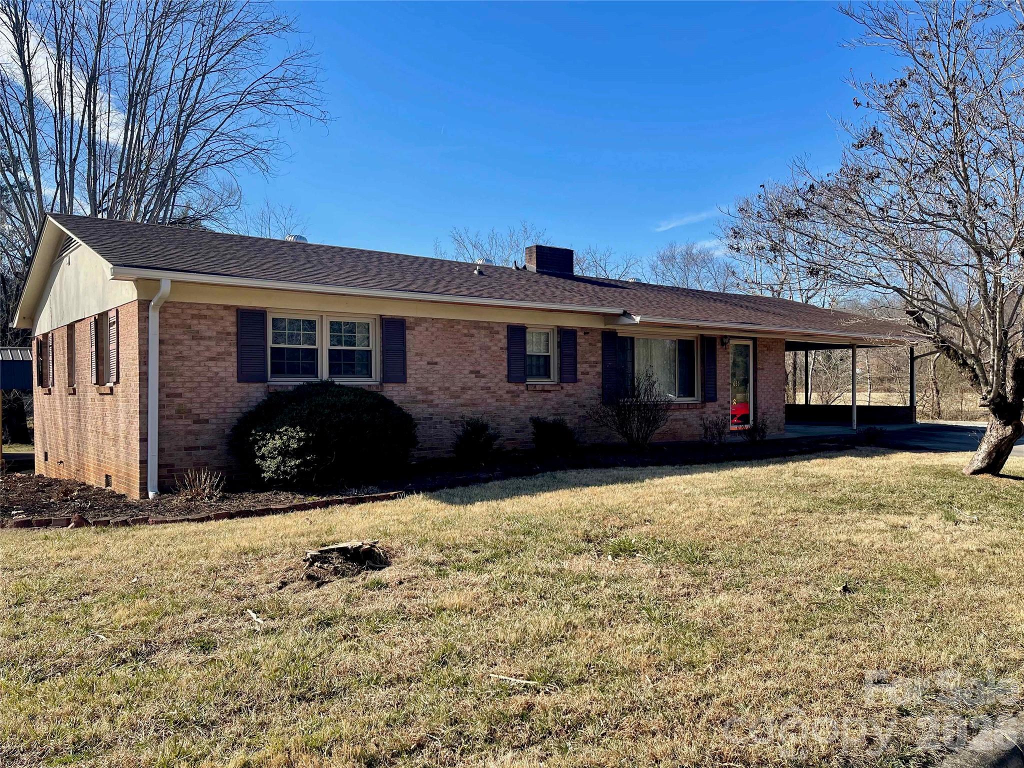 a view of a house with snow on the side of the road