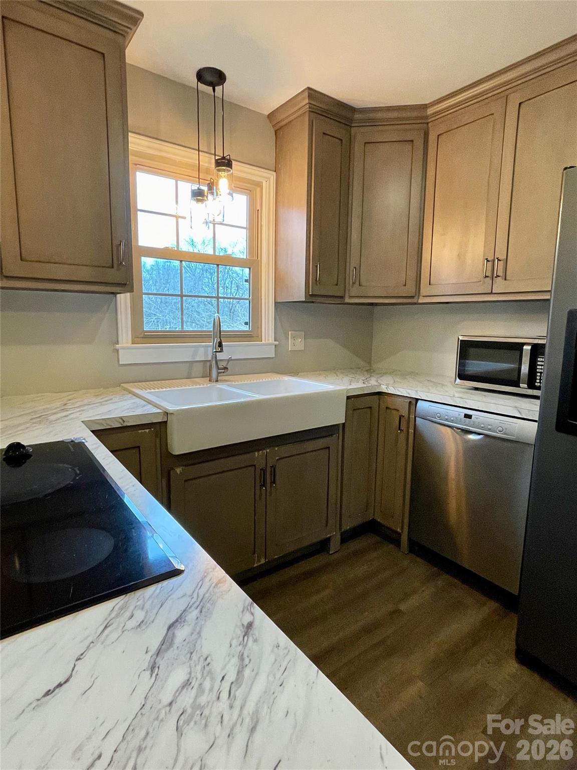 635 Powell Road Northeast Lenoir, NC 28645 - Photo 12 of 48 a kitchen with a sink stove and cabinets