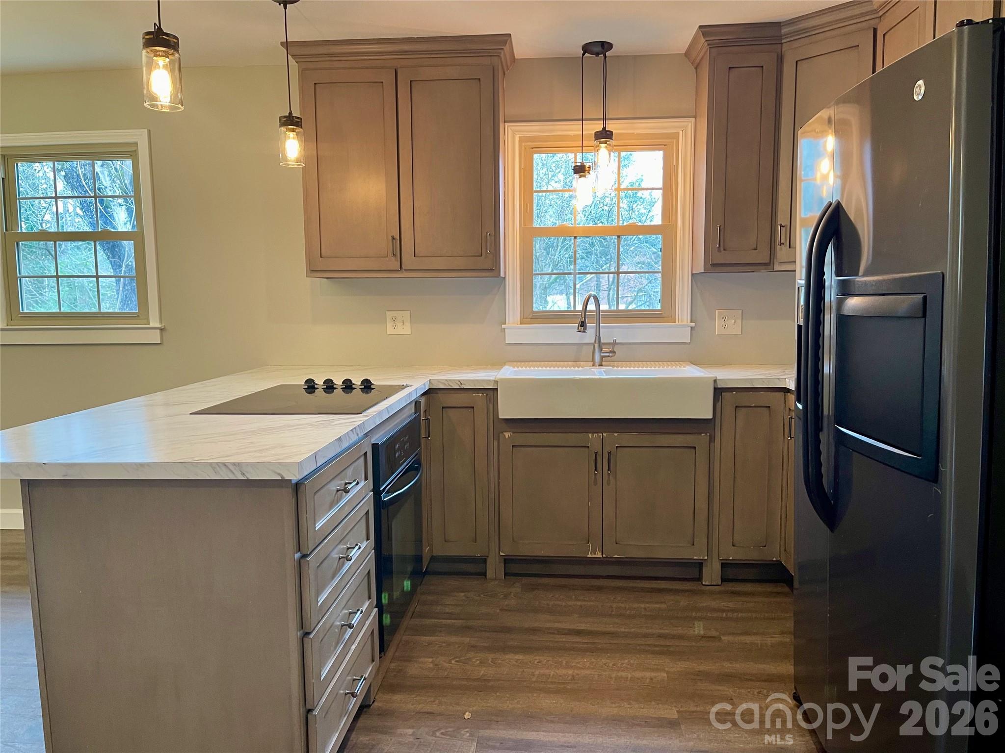 635 Powell Road Northeast Lenoir, NC 28645 - Photo 14 of 48 a kitchen with stainless steel appliances granite countertop a sink stove and refrigerator