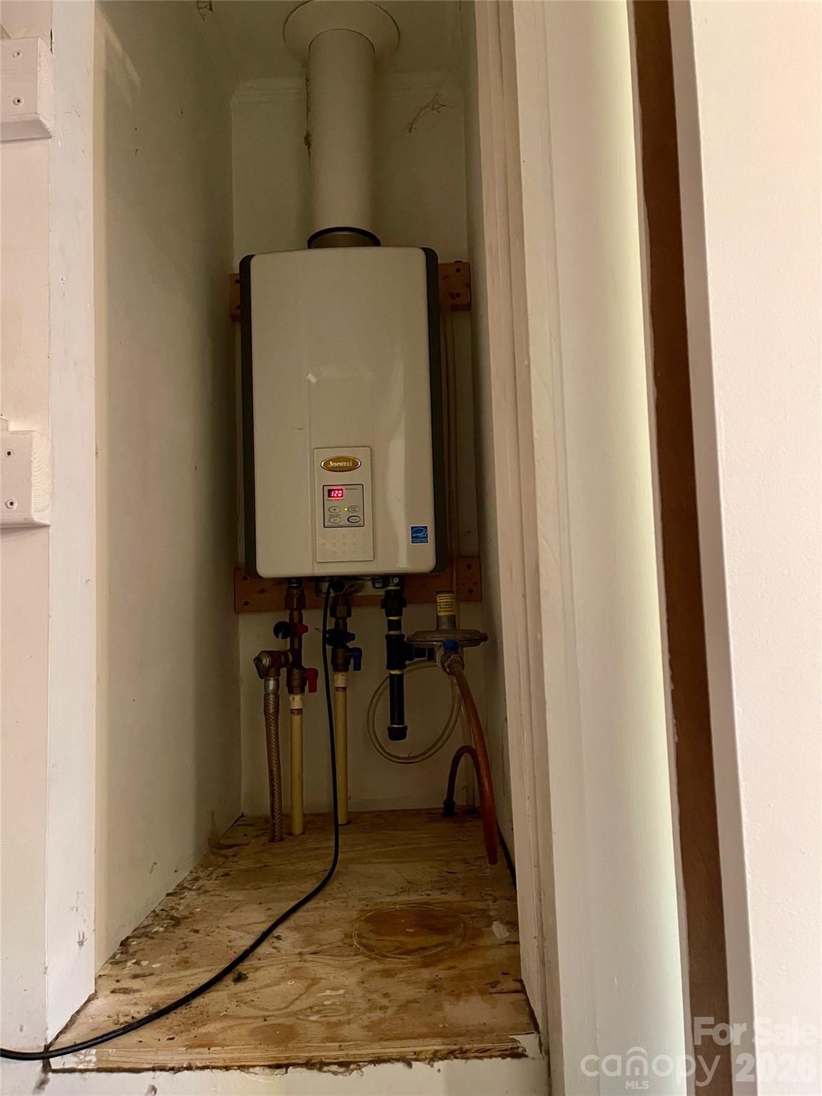 635 Powell Road Northeast Lenoir, NC 28645 - Photo 18 of 48 a room with water heater and a wooden door