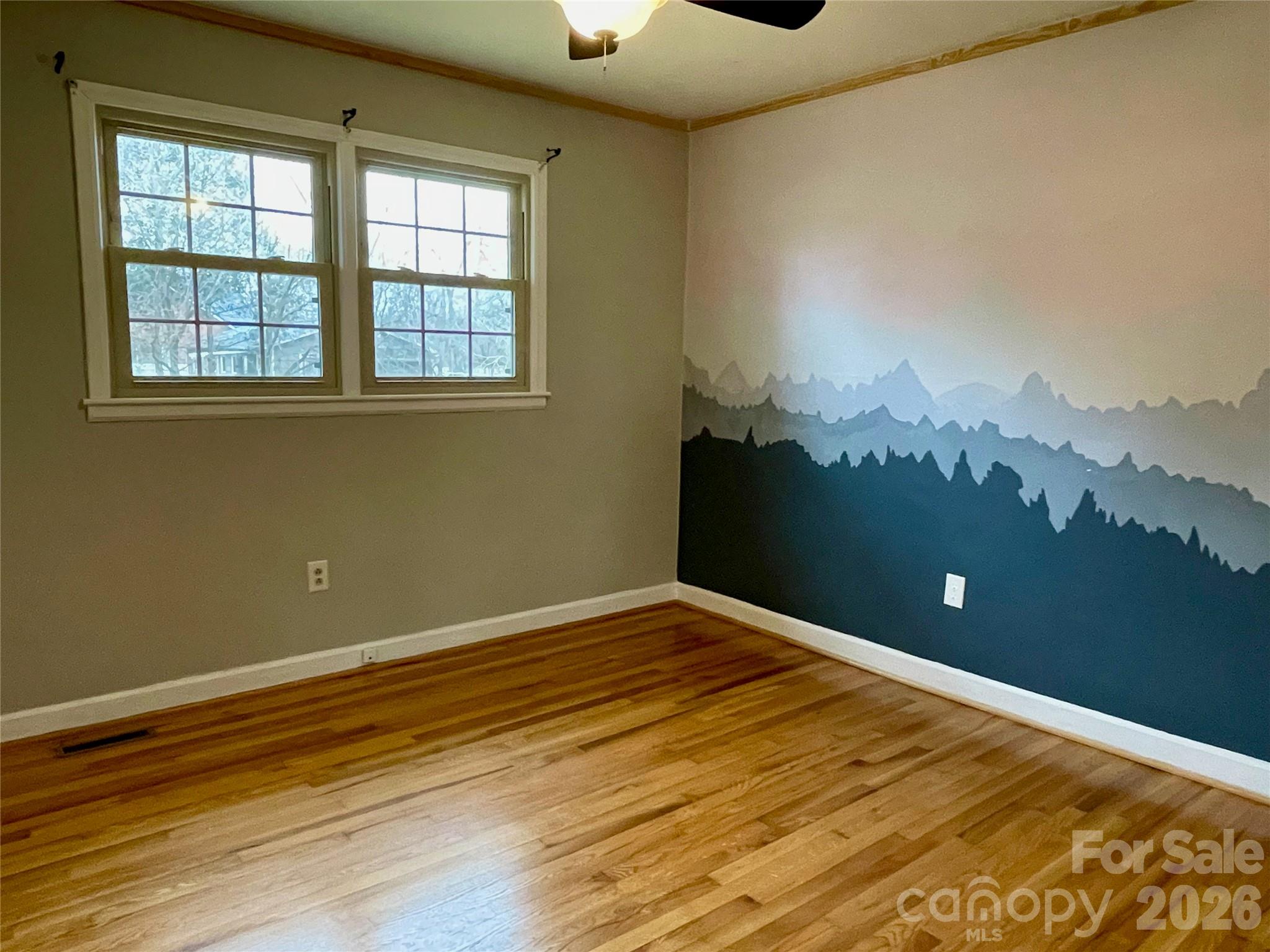 635 Powell Road Northeast Lenoir, NC 28645 - Photo 20 of 48 a view of a big room with wooden floor and windows