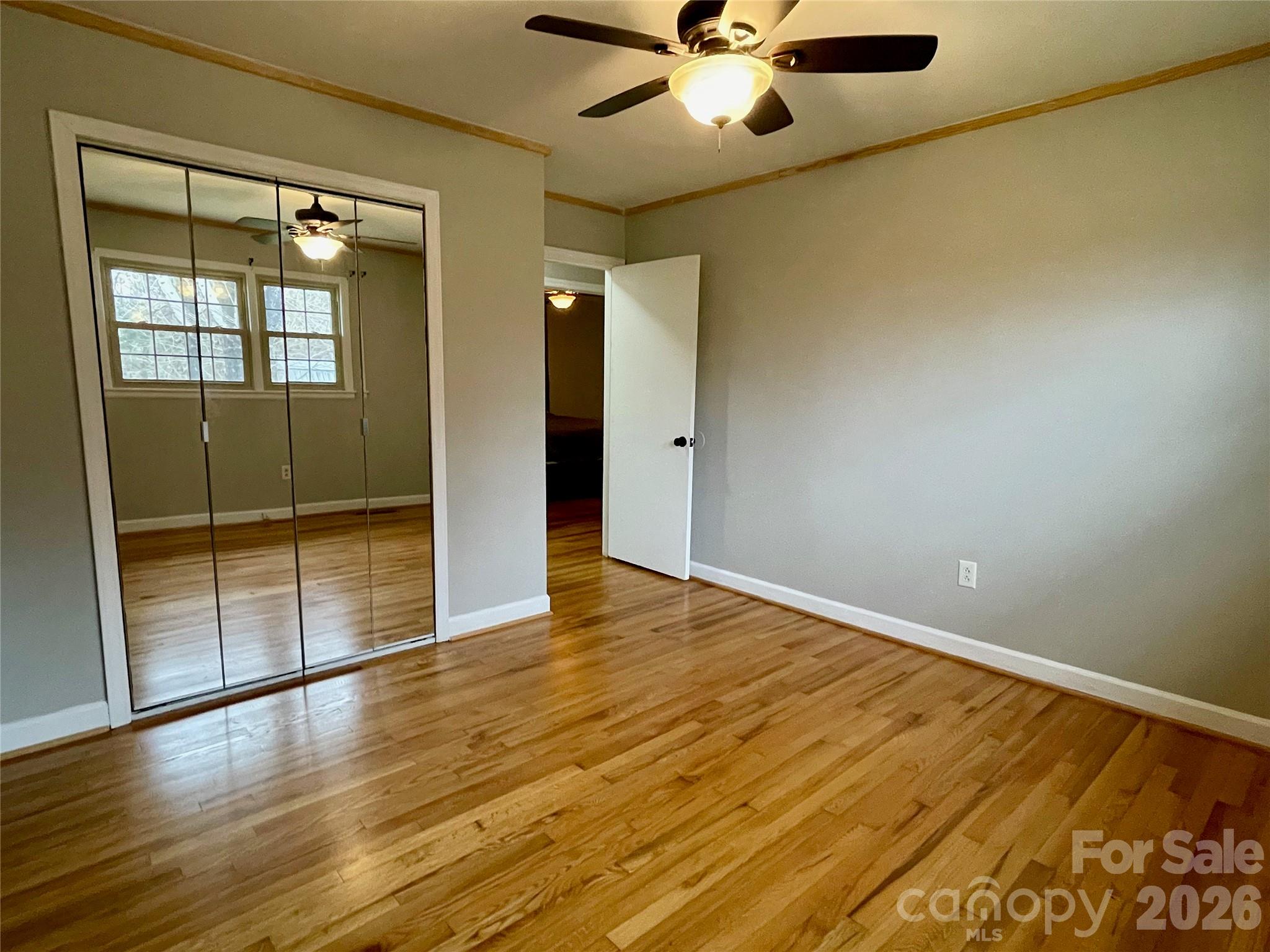 635 Powell Road Northeast Lenoir, NC 28645 - Photo 22 of 48 an empty room with wooden floor and windows