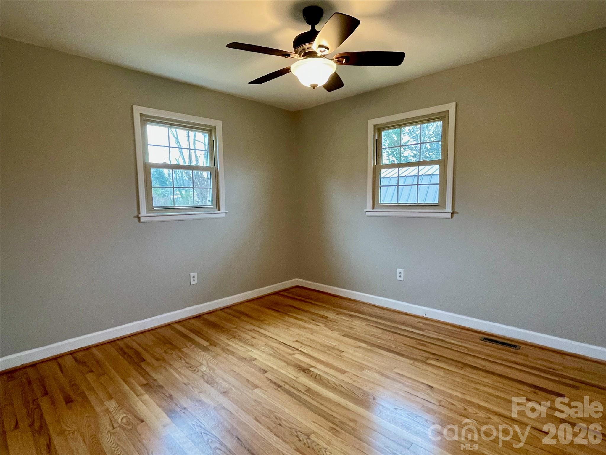 635 Powell Road Northeast Lenoir, NC 28645 - Photo 26 of 48 a view of an empty room with window and wooden floor