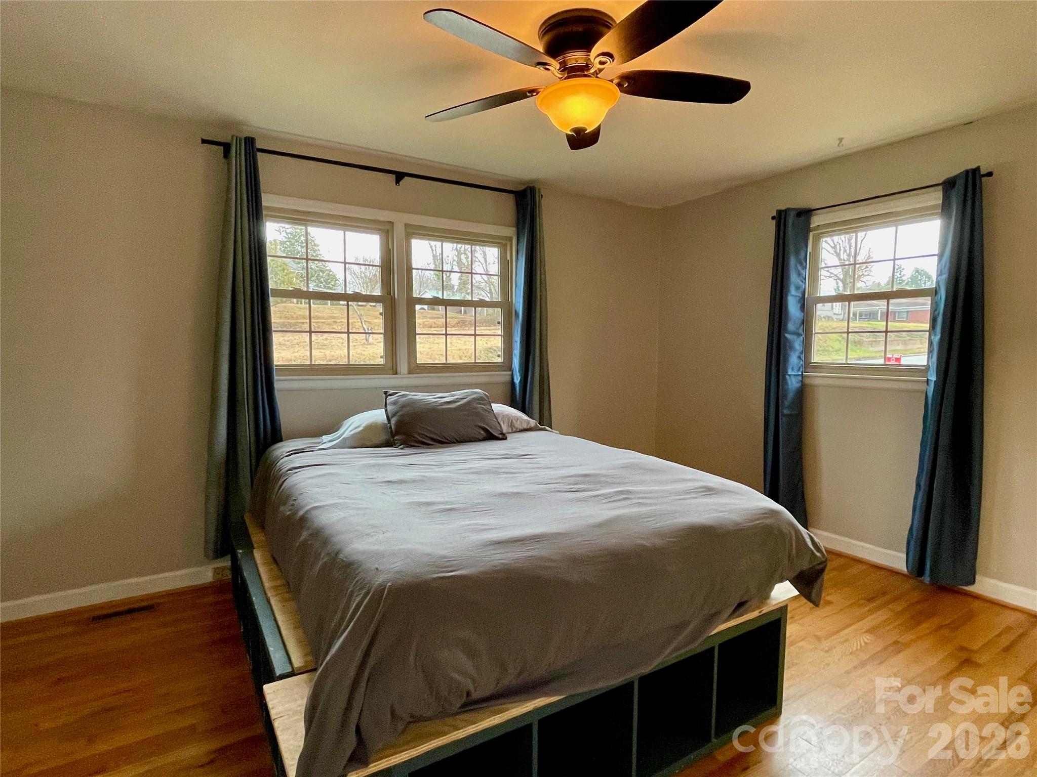 635 Powell Road Northeast Lenoir, NC 28645 - Photo 27 of 48 a bedroom with a bed and wooden floor