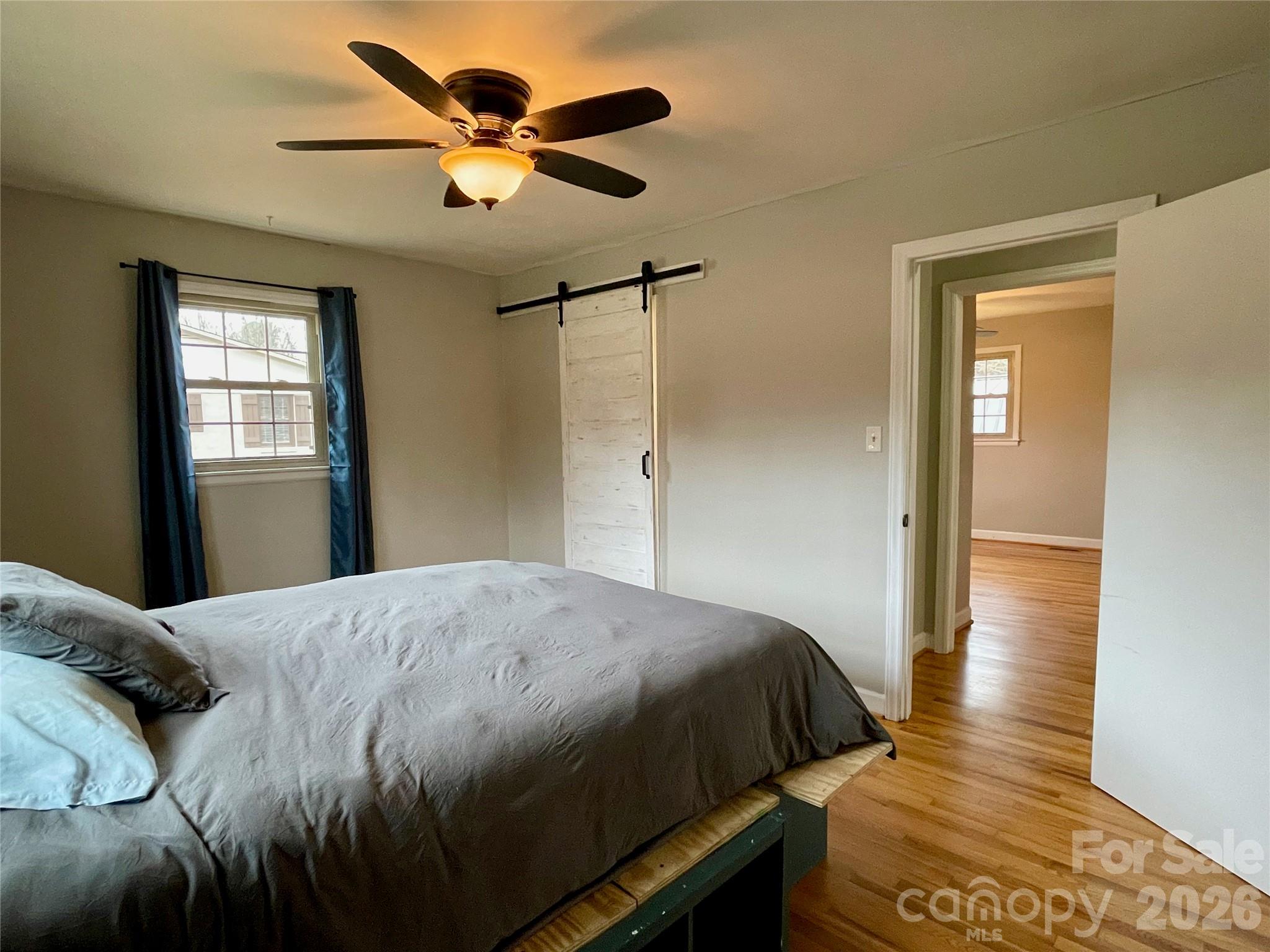 635 Powell Road Northeast Lenoir, NC 28645 - Photo 29 of 48 a bedroom with a bed and a chandelier