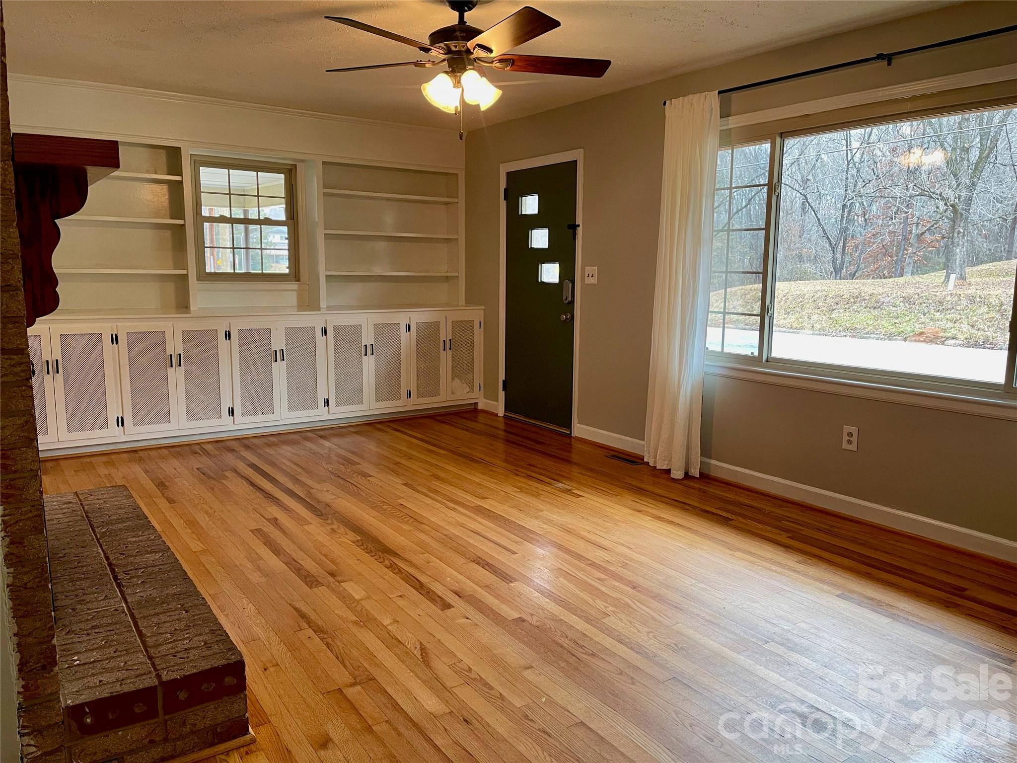 635 Powell Road Northeast Lenoir, NC 28645 - Photo 3 of 48 a view of an empty room with wooden floor and a window