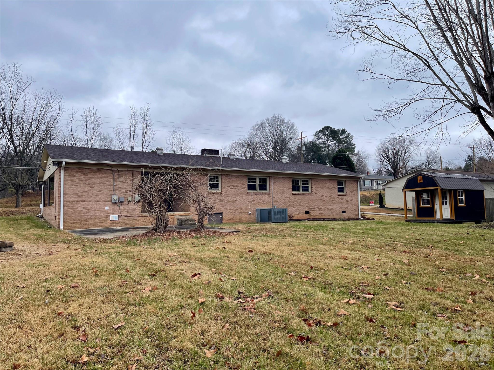 635 Powell Road Northeast Lenoir, NC 28645 - Photo 37 of 48 a view of a house with backyard and a tree