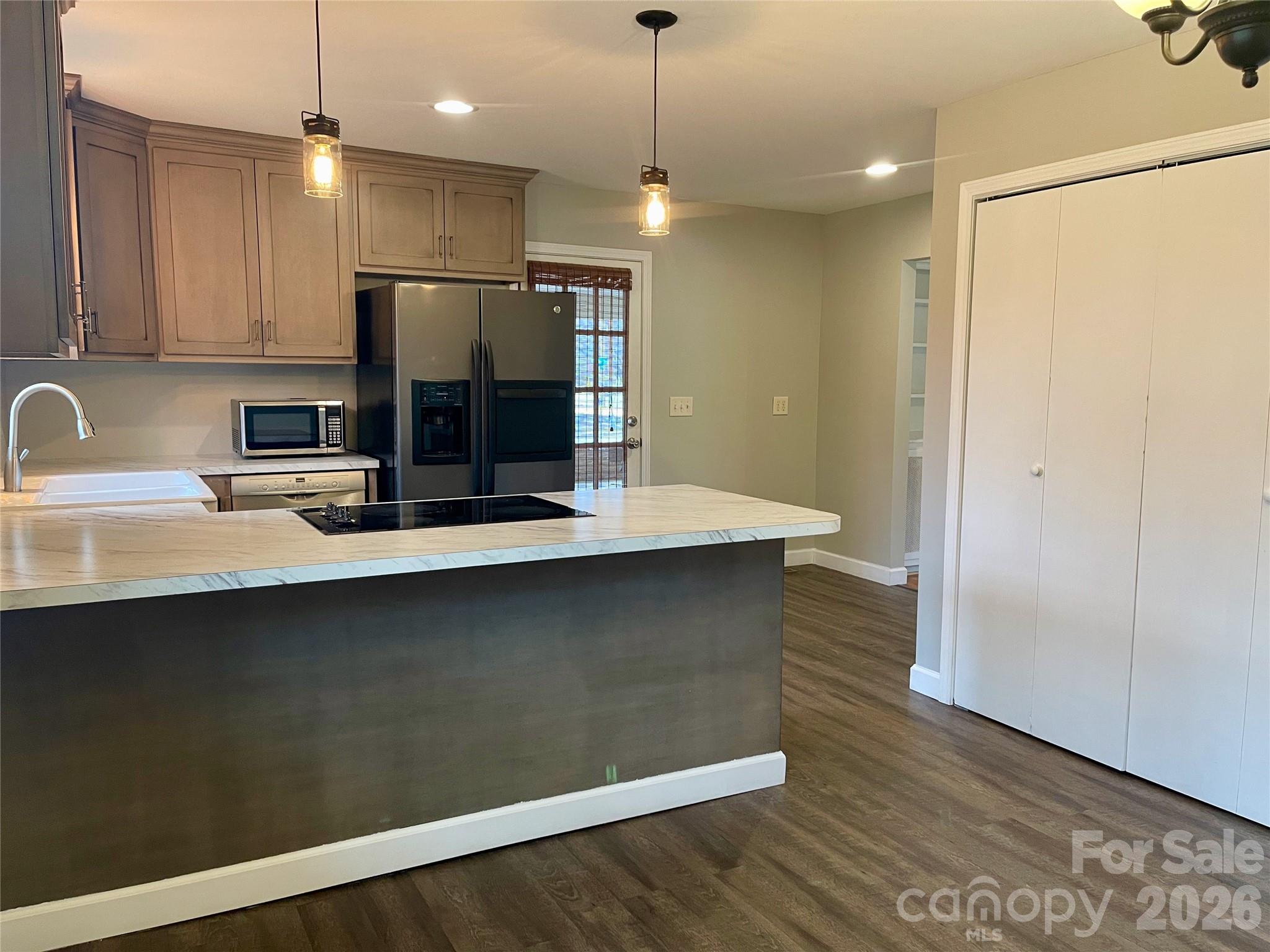 635 Powell Road Northeast Lenoir, NC 28645 - Photo 10 of 48 a kitchen with stainless steel appliances a refrigerator sink and microwave