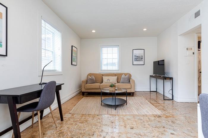 212 Kirkwood Road Northeast, Unit 2 Atlanta, GA 30317 - Photo 1 of 1 a living room with furniture a rug and a window