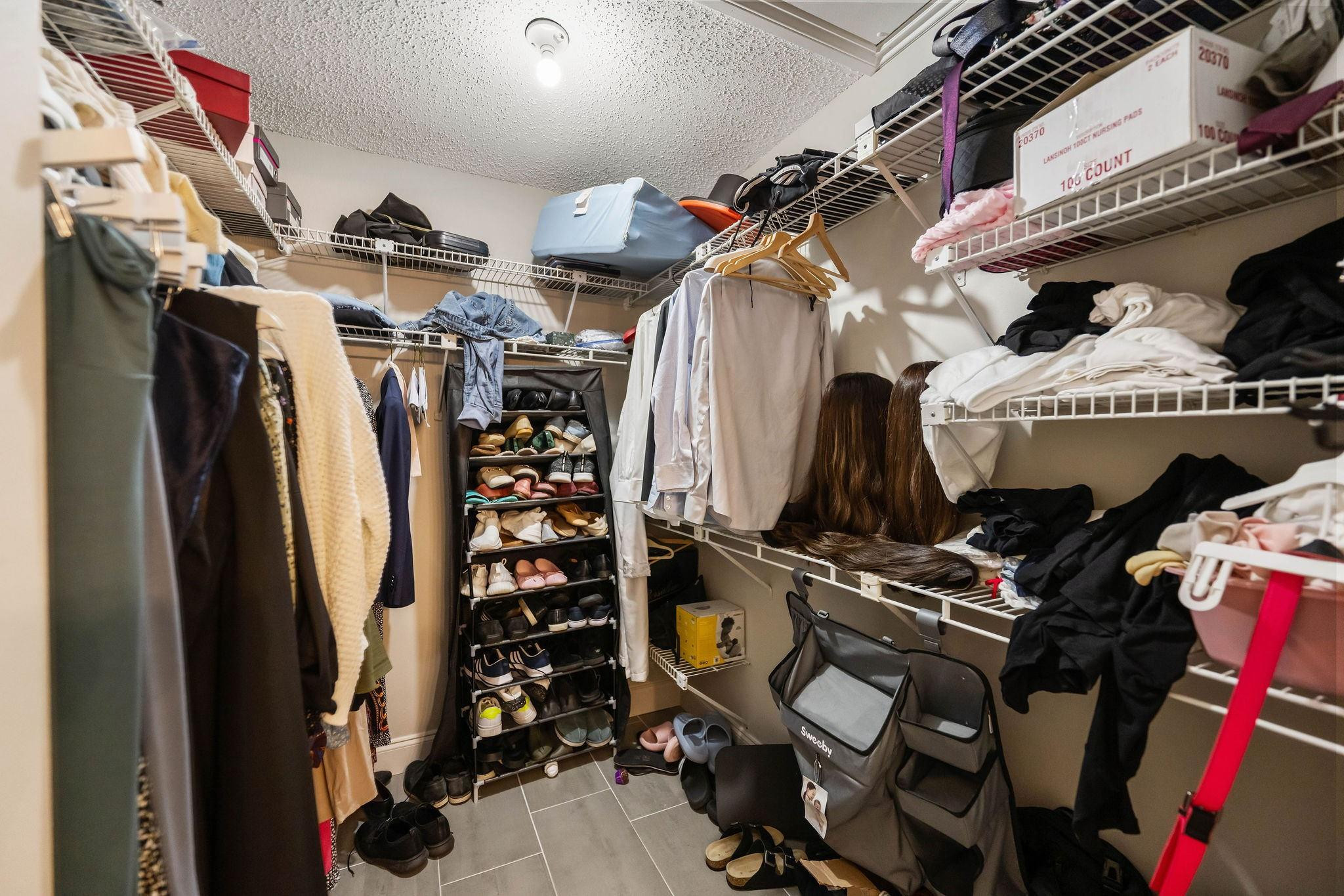 7427 Chablis Court Boca Raton, FL 33433 - Photo 8 of 12 a view of walk in closet with clothes and shoes