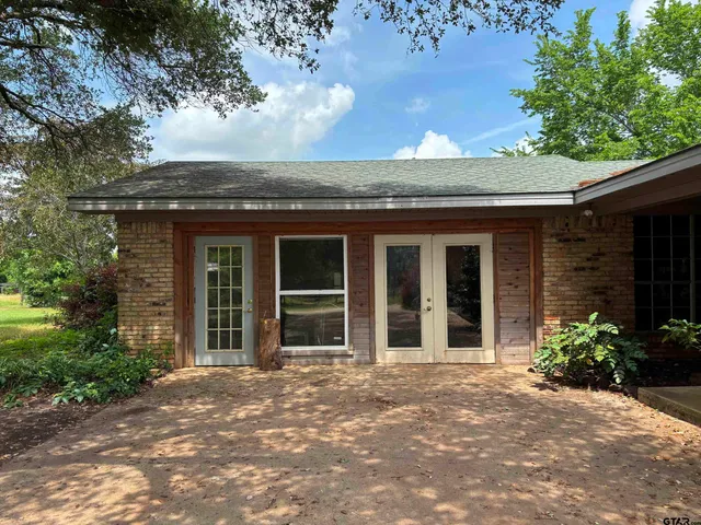 a view of house with backyard