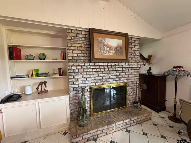 a room with pool table and paintings on the wall