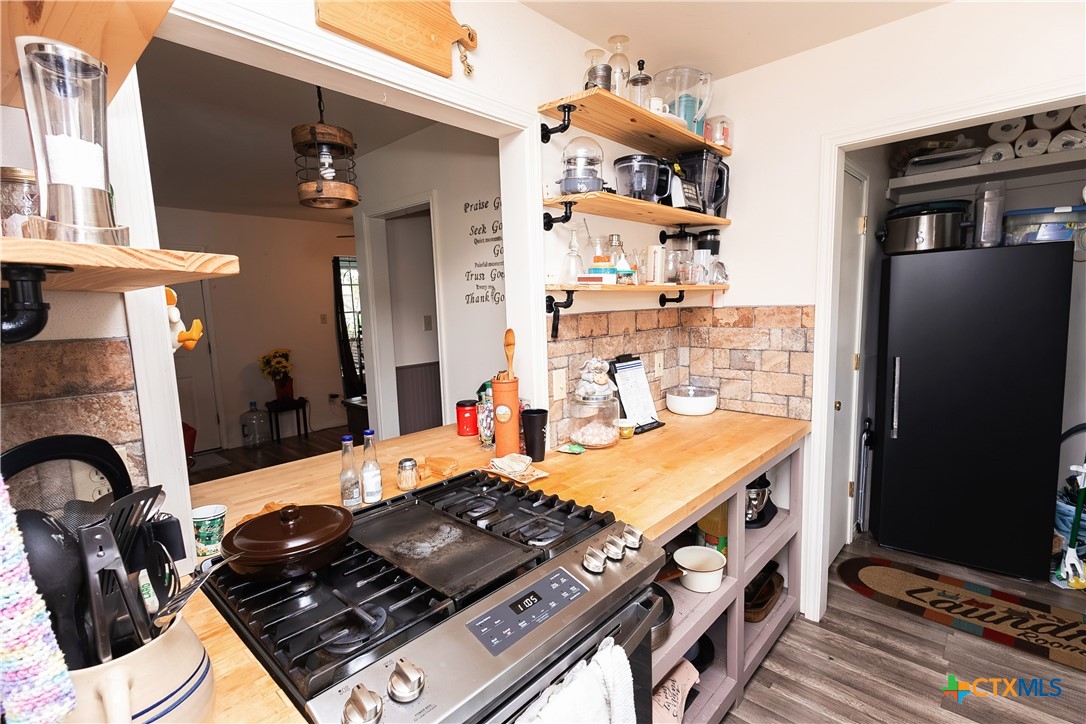 802 Bay Street Austwell, TX 77950 - Photo 9 of 27 a kitchen with a stove and a refrigerator