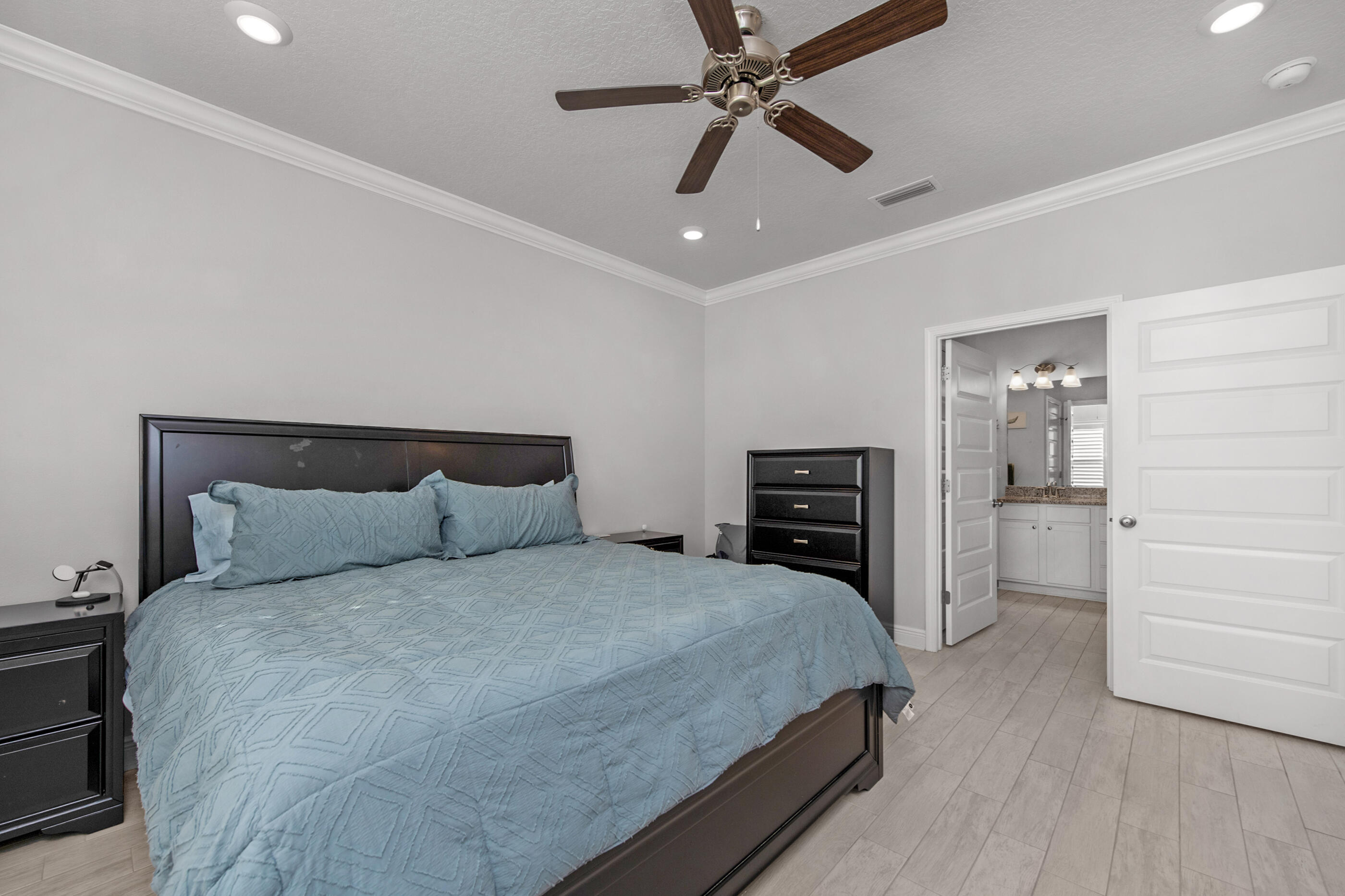 382 Lightning Bug Lane Freeport, FL 32439 - Photo 17 of 33 a bedroom with a bed and ceiling fan