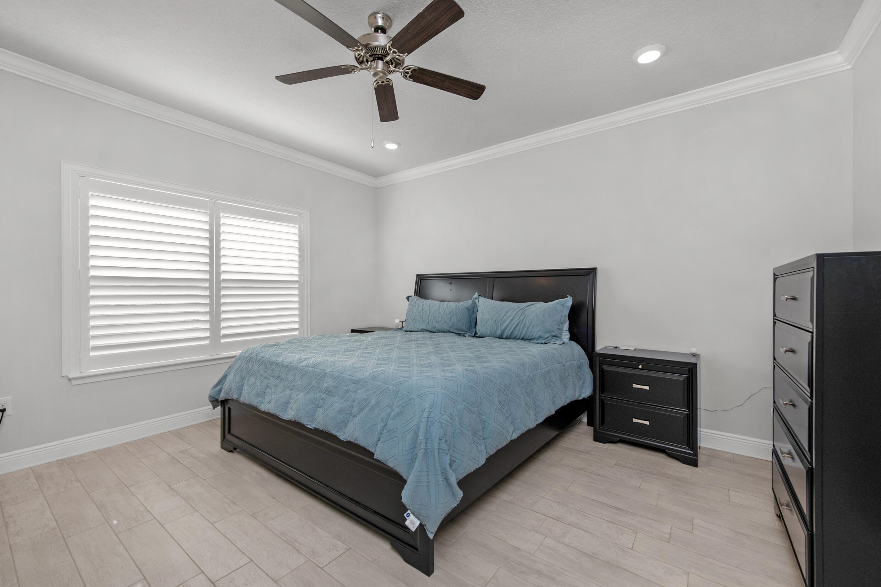 382 Lightning Bug Lane Freeport, FL 32439 - Photo 18 of 33 a bedroom with a bed and a ceiling fan