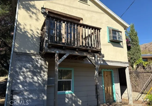 a view of a house with a wooden deck