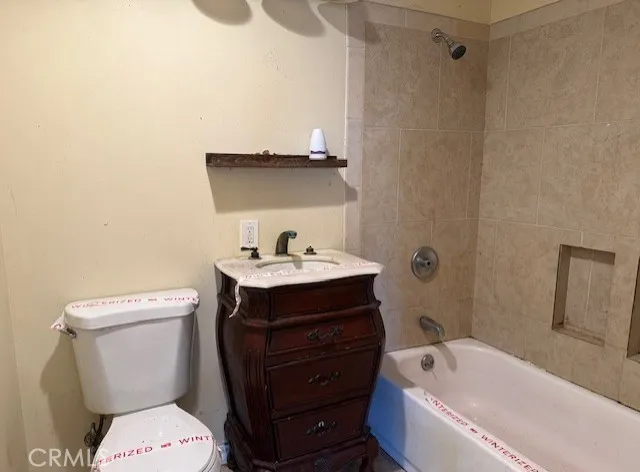 a bathroom with a sink a toilet and bathtub