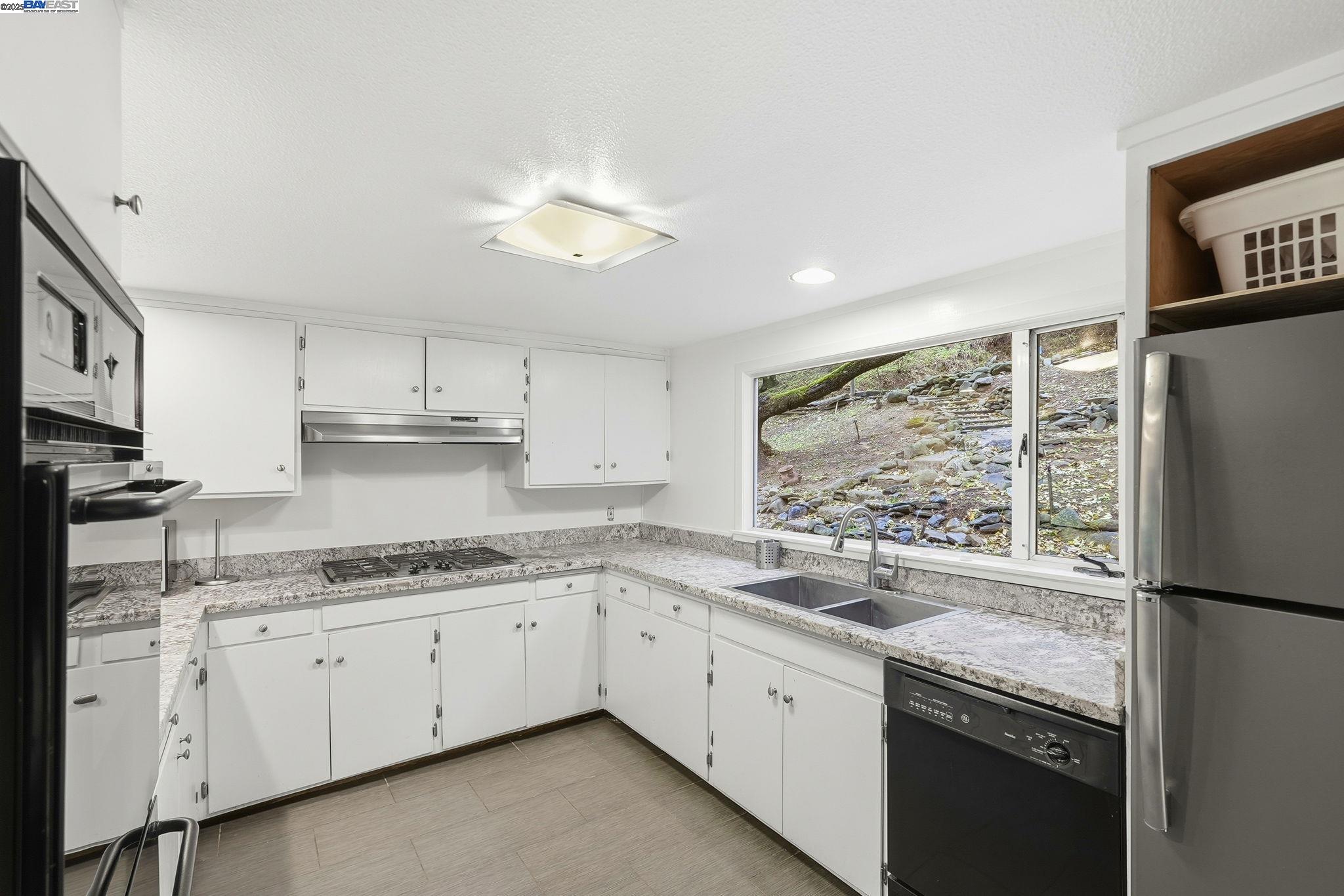 2929 Kilkare Road Sunol, CA 94586 - Photo 16 of 40 a kitchen with stainless steel appliances granite countertop a refrigerator sink and stove