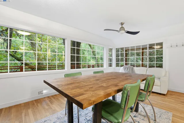 a view of a dining room with furniture window and wooden floor