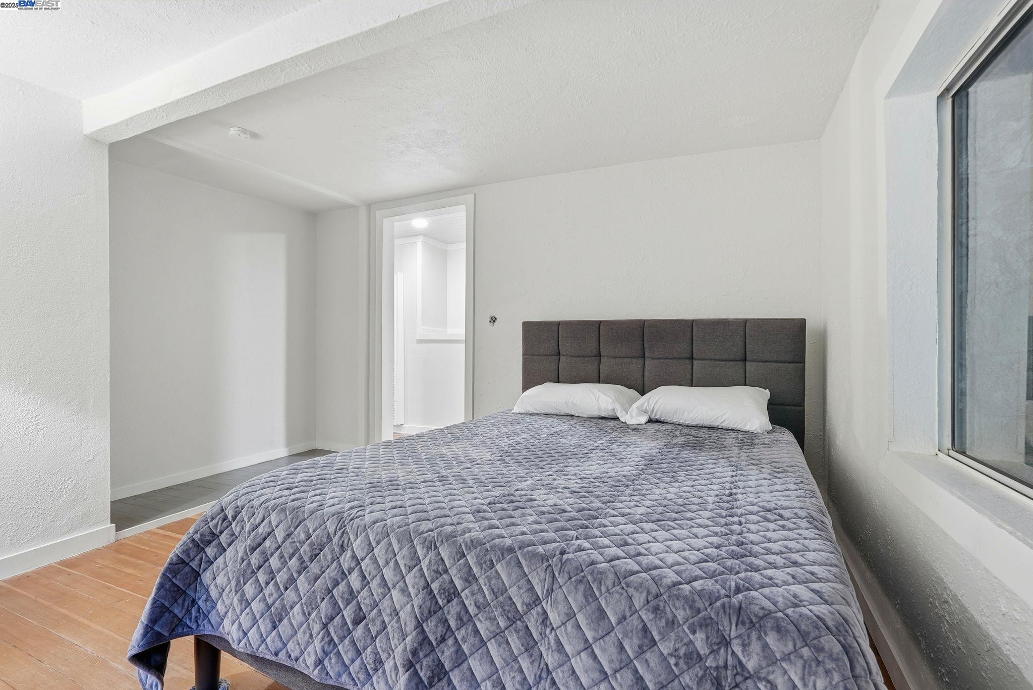 2929 Kilkare Road Sunol, CA 94586 - Photo 27 of 40 a large bed sitting in a bedroom next to a window and a wooden floor