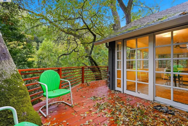 a porch with a bench in front of a yard