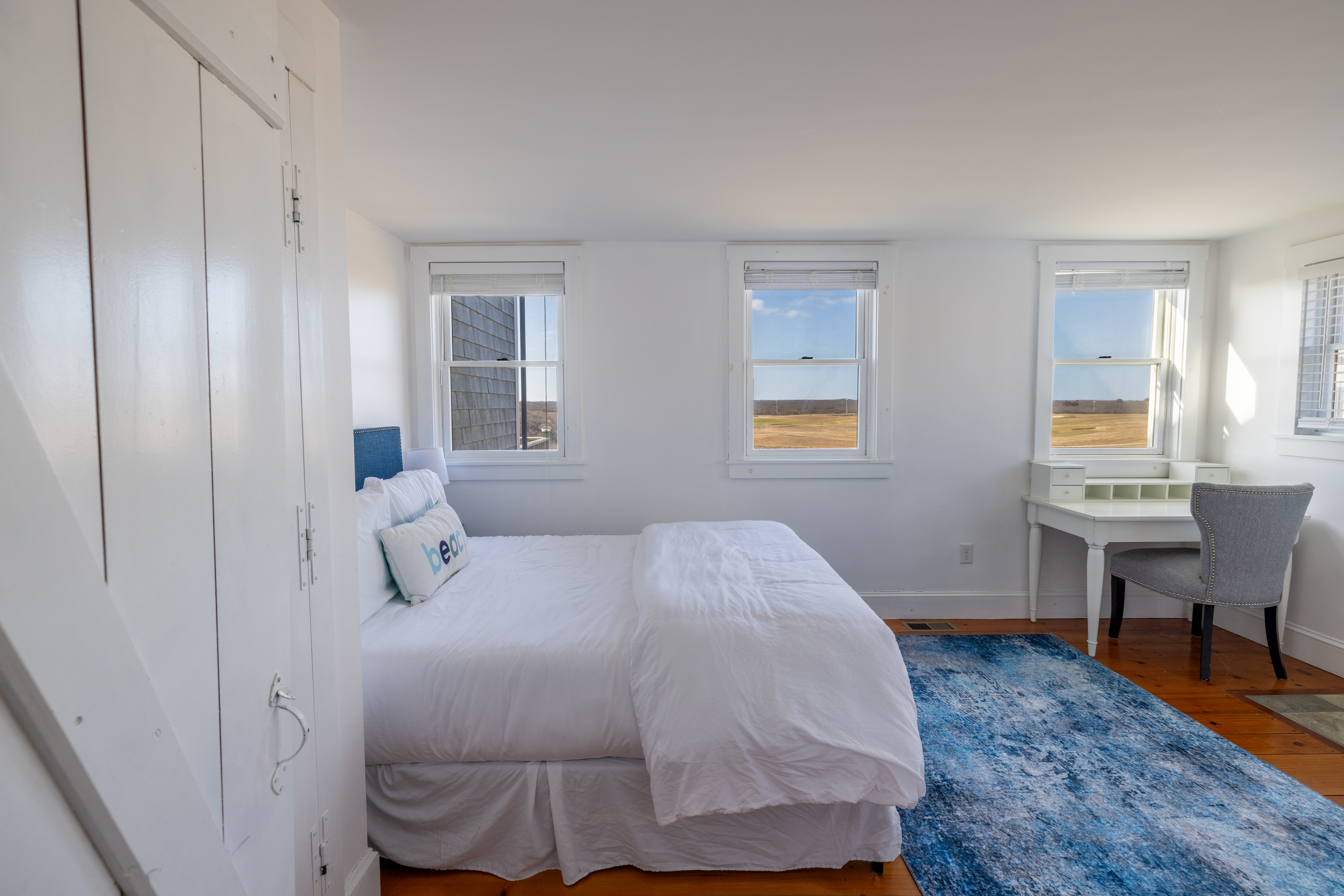 116 Baxter Road Nantucket, MA 02554 - Photo 21 of 28 a bedroom with a bed and a table in it