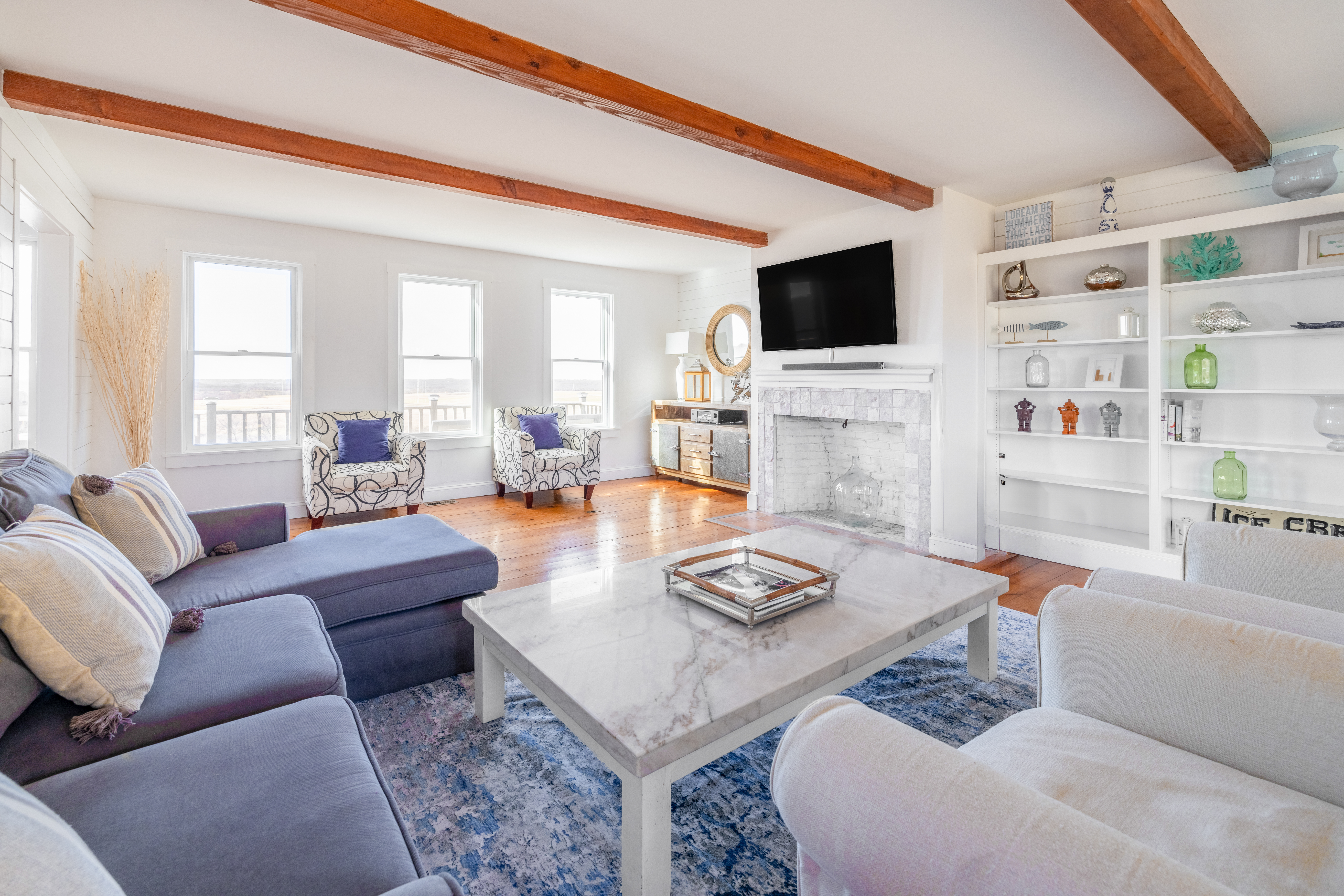 116 Baxter Road Nantucket, MA 02554 - Photo 3 of 28 a living room with furniture a flat screen tv and a fireplace