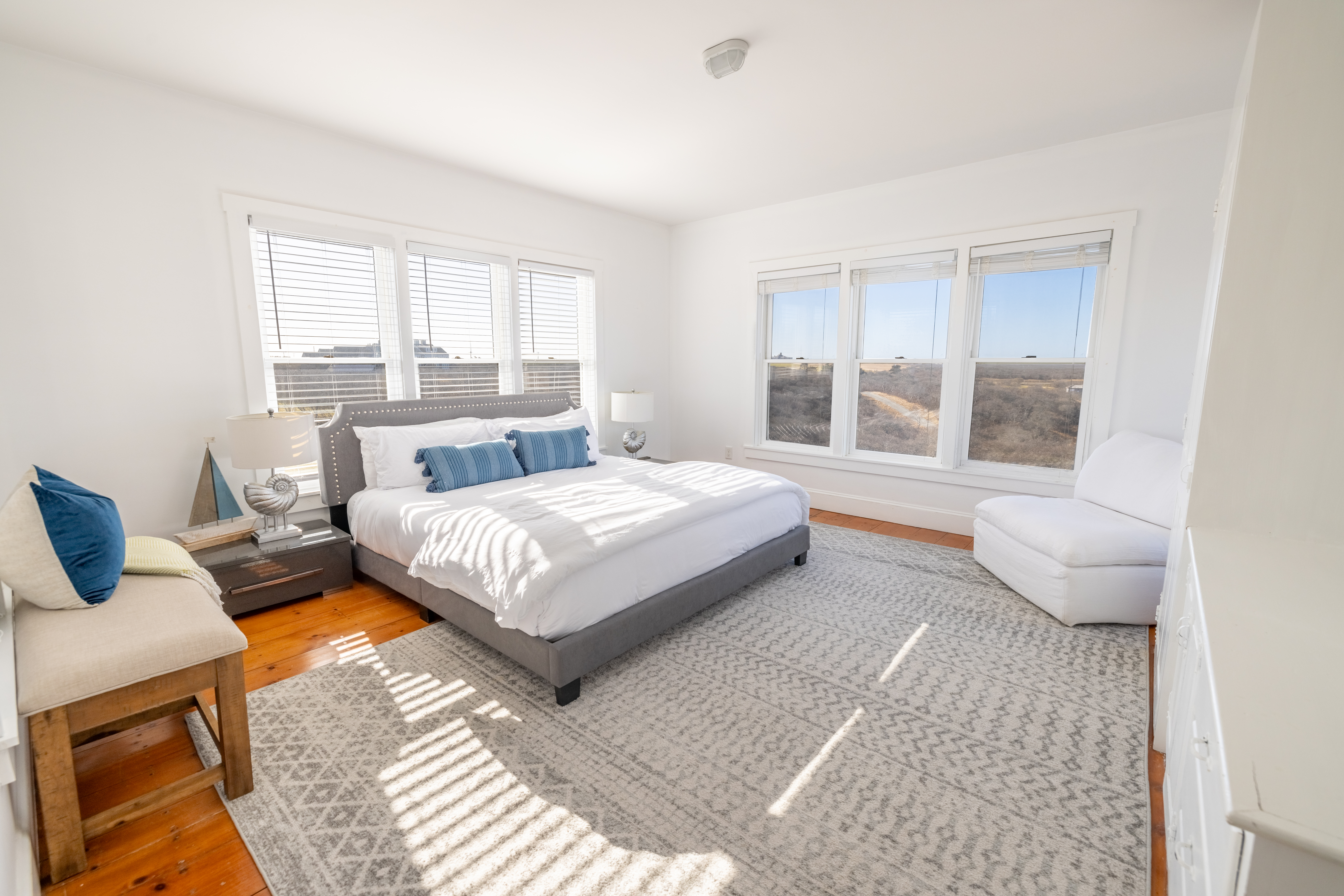 116 Baxter Road Nantucket, MA 02554 - Photo 6 of 28 a spacious bedroom with a bed and glass window