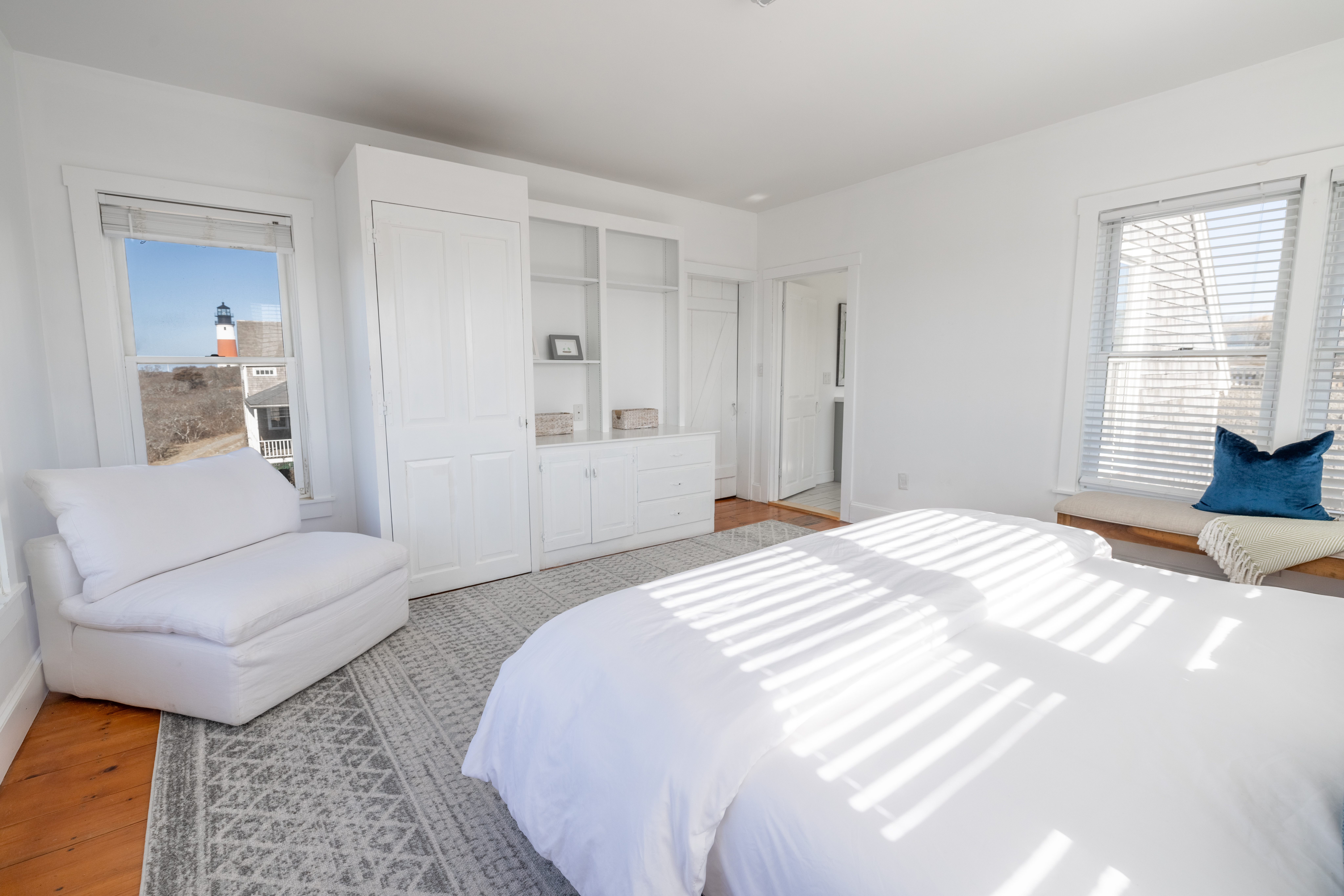 116 Baxter Road Nantucket, MA 02554 - Photo 7 of 28 a spacious bedroom with a bed and a couch