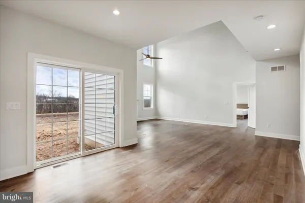 a spacious bedroom with a bed and a window
