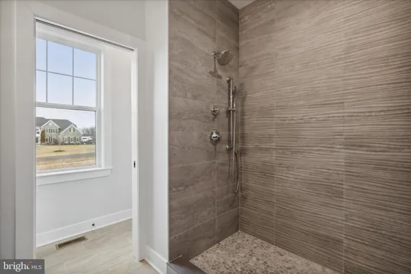 an empty room with a window and a ceiling fan