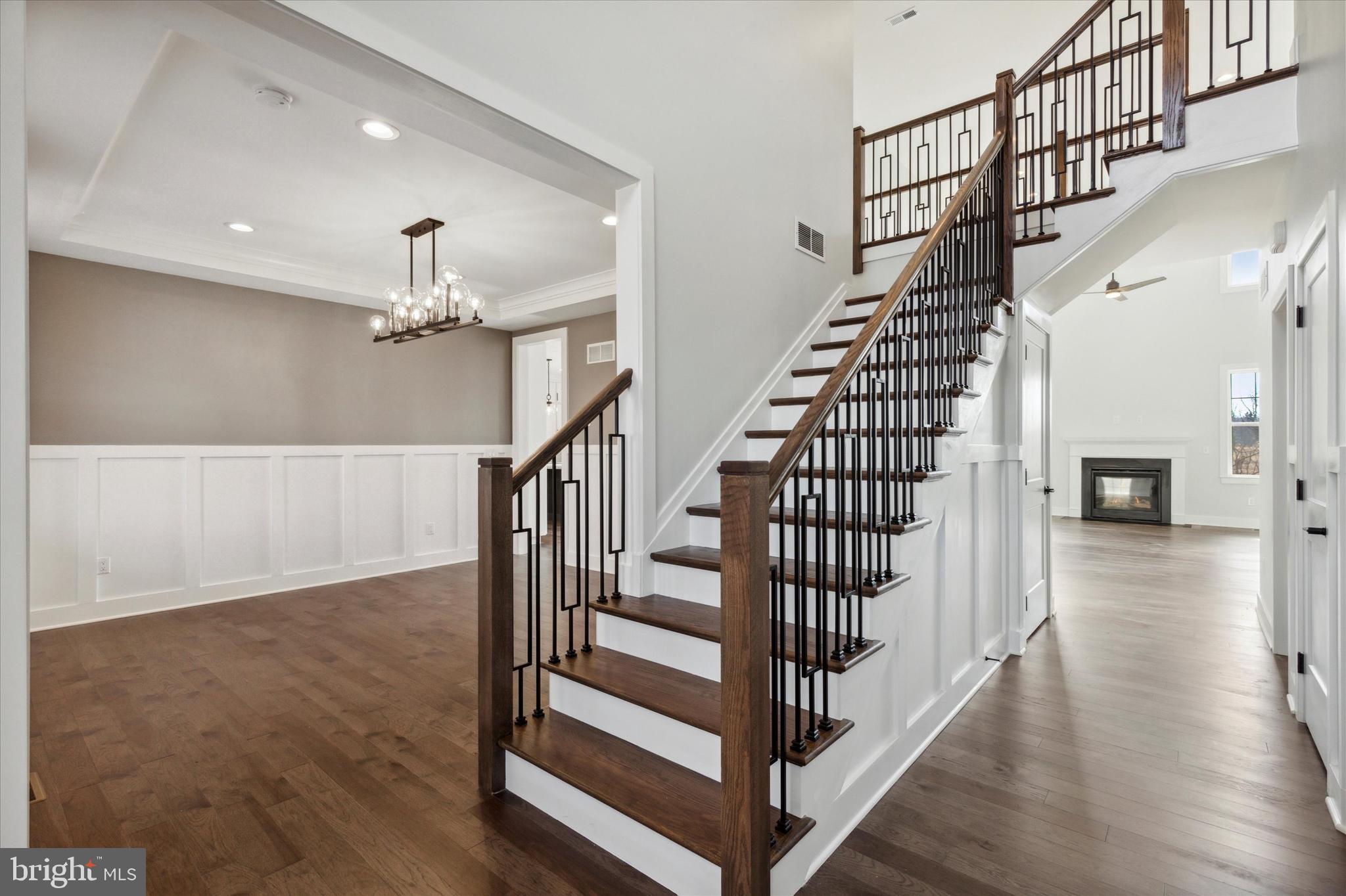 124 Schultz Road Sellersville, PA 18960 - Photo 7 of 30 a view of staircase with wooden floor and pendant lights