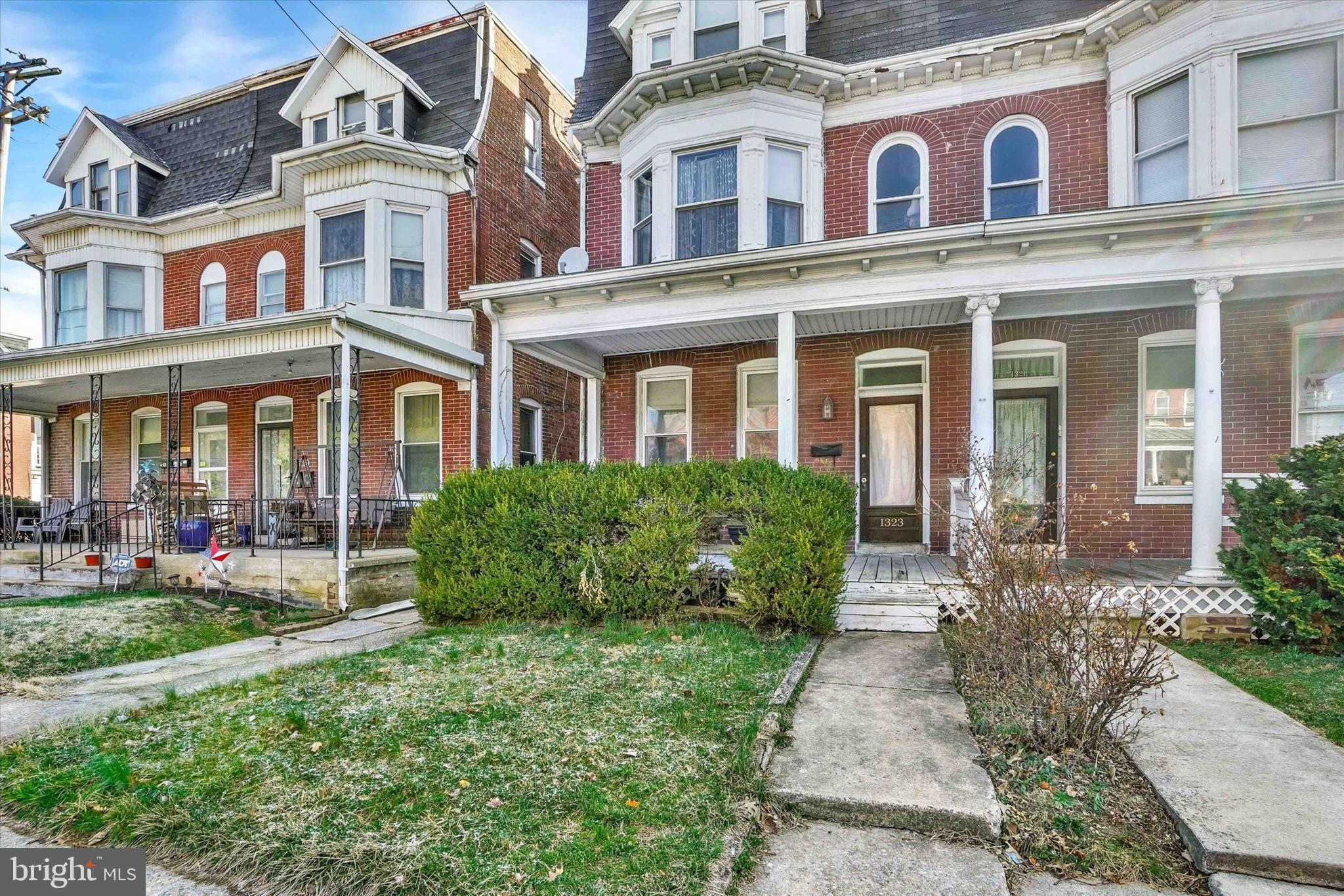 1323 North George Street York, PA 17404 - Photo 2 of 27 front view of a brick house with a yard