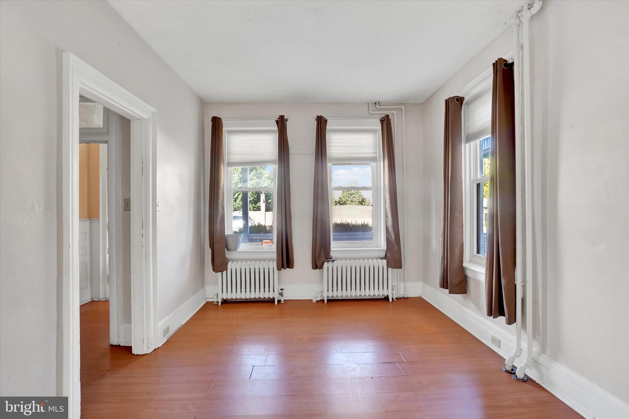 1323 North George Street York, PA 17404 - Photo 5 of 27 a view of an empty room with wooden floor and windows