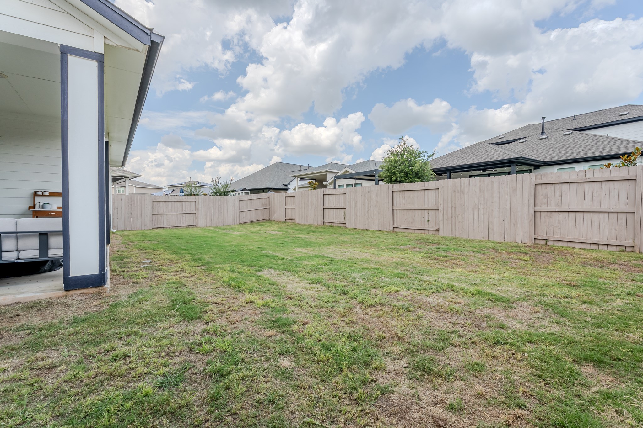8109 Edmondson Bend Austin, TX 78744 - Photo 35 of 38 A spacious, enclosed backyard offers a private green oasis.