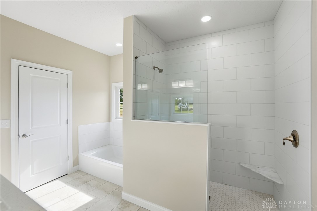 4600 Beal Road Franklin, OH 45005 - Photo 21 of 42 This spacious bathroom offers a relaxing soaking tub and a sleek walk-in shower with modern tile.