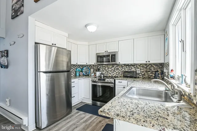 a kitchen with a refrigerator sink and microwave