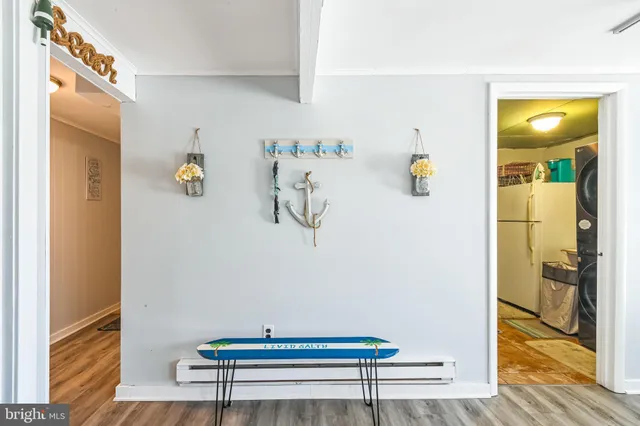 a view of dining room with wooden floor and cabinet