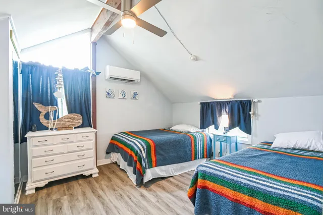 a bedroom with bed and wooden floor