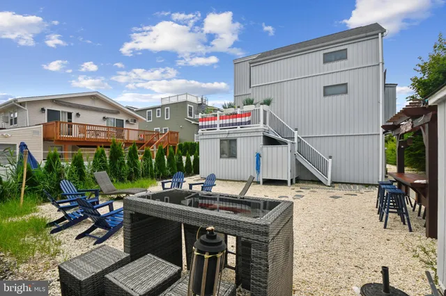 a view of outdoor kitchen outdoor dining table and chairs