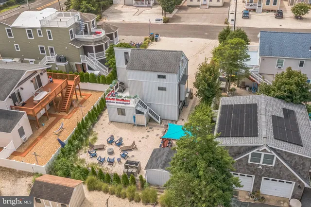 an aerial view of a house with garden space and street view