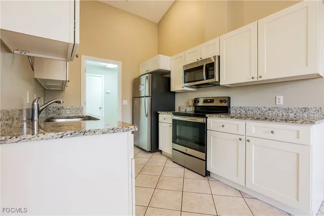 a kitchen with stainless steel appliances granite countertop a sink and a stove