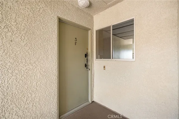 a living room with furniture and a dining table with wooden floor