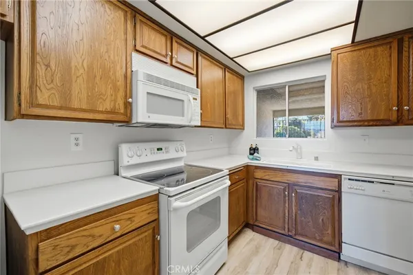a kitchen with kitchen island a sink and wooden floor