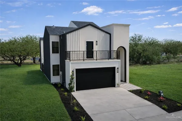 a front view of a house with a garden and yard