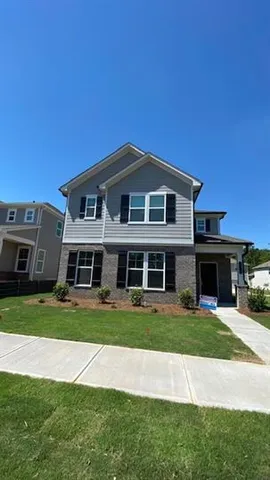a front view of a house with a yard