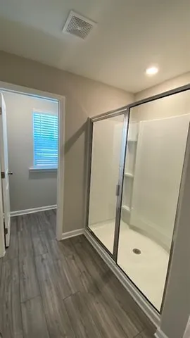 a bathroom with a glass shower door