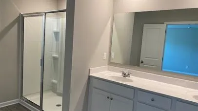 a bathroom with a double vanity sink and a mirror